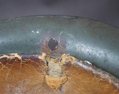 Combat damaged M42 SS helmet