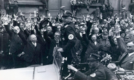 Himmler and Wolff in grey overcoat with black collar and black cap....